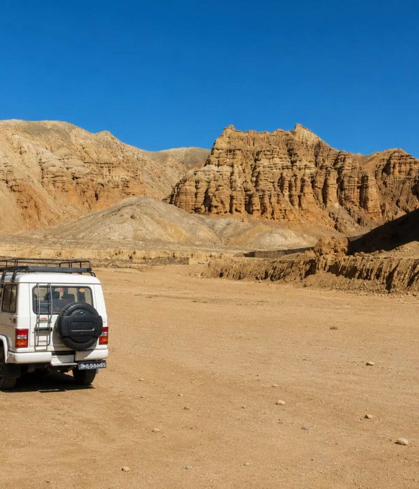 4WD jeep exploring the dramatic desert landscape on the Upper Mustang Overland Tour in Nepal