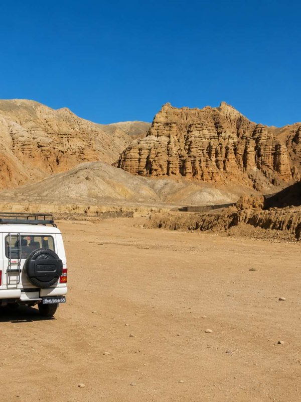 4WD jeep exploring the dramatic desert landscape on the Upper Mustang Overland Tour in Nepal