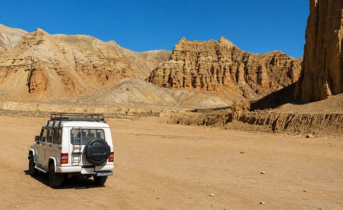 4WD jeep exploring the dramatic desert landscape on the Upper Mustang Overland Tour in Nepal