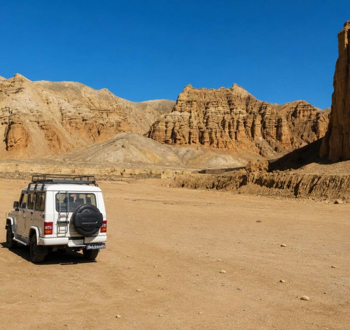 4WD jeep exploring the dramatic desert landscape on the Upper Mustang Overland Tour in Nepal