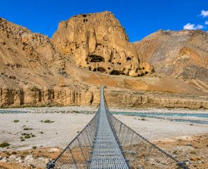 Upper Mustang Tour – Chhoser Sky Caves in Nepal Ancient Chhoser Sky Caves and suspension bridge on the Upper Mustang Tour in Nepal