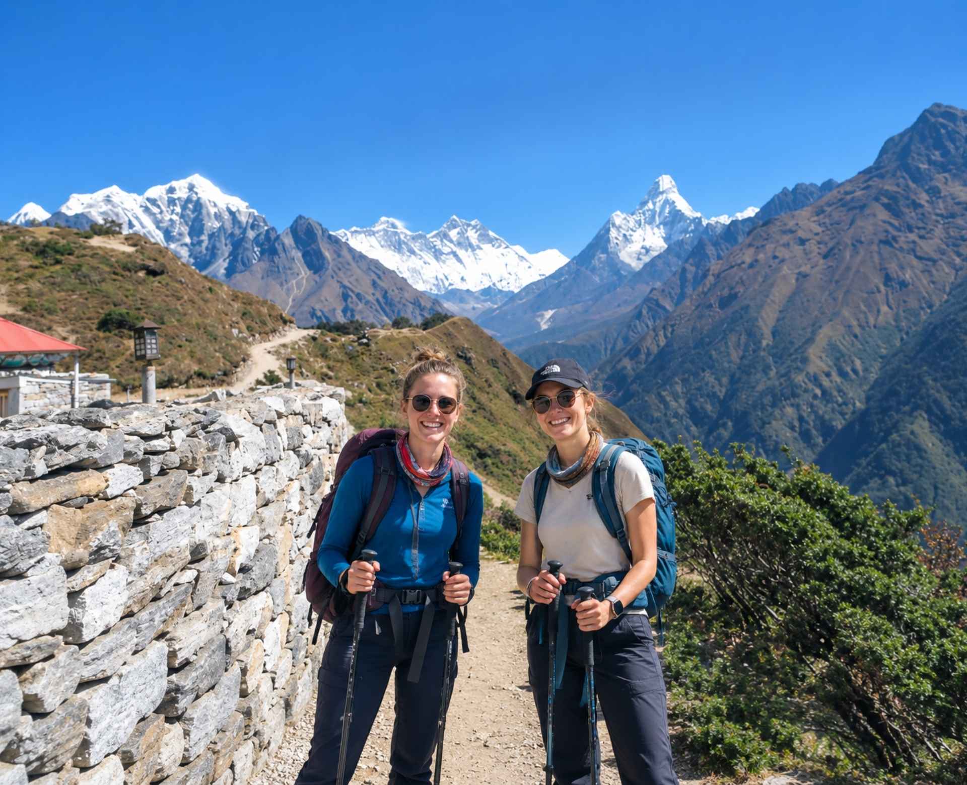 Two trekkers walking on the Everest View Trek trail with Himalayan mountain views