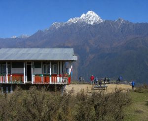 Mountain Lodge with Himalayan Views Mountain lodge with a snow-covered Himalayan peak in the background
