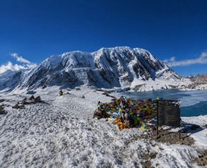 Tilicho Lake surrounded by snow-covered mountains