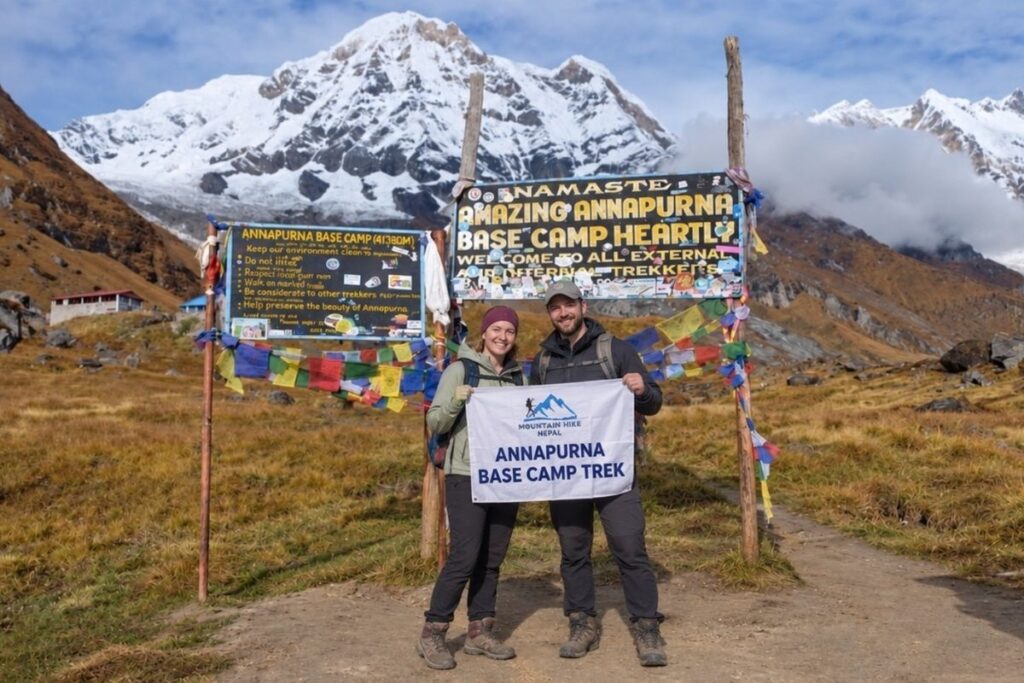 Trekkers at Annapurna Base Camp with the Annapurna mountains behind them