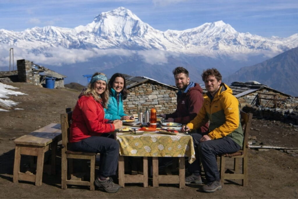 Trekkers having a meal at a mountain lodge on the Dhaulagiri Annapurna Community Trek
