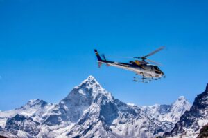 Helicopter flying over snow-covered Himalayan mountains during an Everest Base Camp helicopter tour in Nepal
