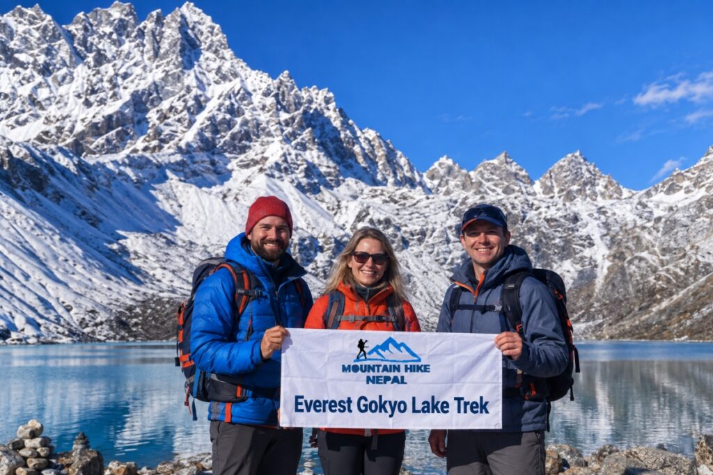 Trekkers holding a Mountain Hike Nepal banner at Gokyo Lake
