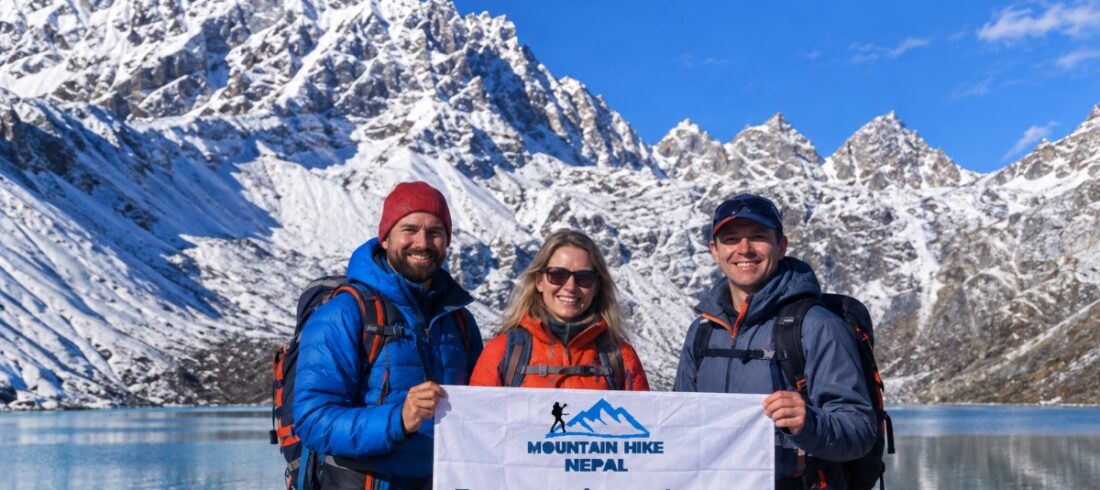 Trekkers holding a Mountain Hike Nepal banner at Gokyo Lake