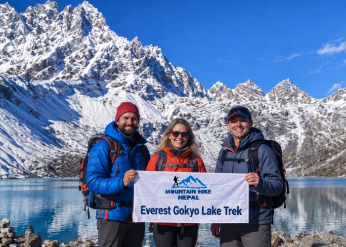 Trekkers holding a Mountain Hike Nepal banner at Gokyo Lake
