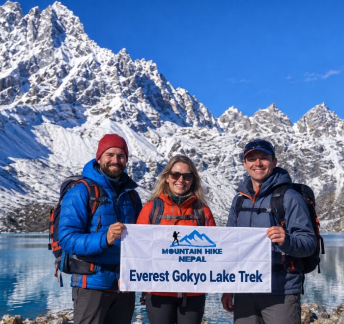 Trekkers holding a Mountain Hike Nepal banner at Gokyo Lake