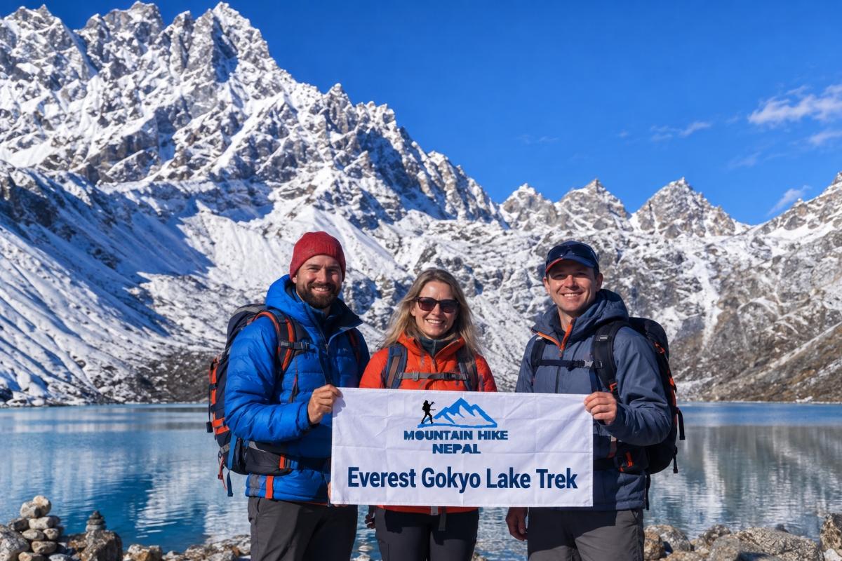 Trekkers holding a Mountain Hike Nepal banner at Gokyo Lake