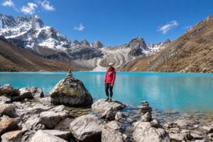 Gokyo Lake Trek – Trekker beside the Lake in Nepal Trekker standing beside Gokyo Lake in the Everest region of Nepal