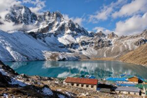 Gokyo Lake and Village – Everest Region, Nepal Gokyo Lake and village surrounded by snow-covered mountains in Nepal