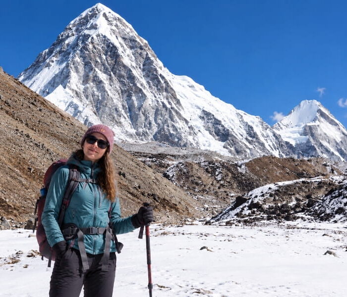Trekker with Mount Pumori during the Everest Base Camp trek in Nepal
