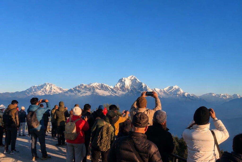 Trekkers photographing Mount Dhaulagiri from Poon Hill viewpoint in Nepal