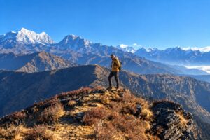 Pikey Peak Trek High Ridge View Trekker standing on the high ridge of Pikey Peak with Himalayan mountains behind