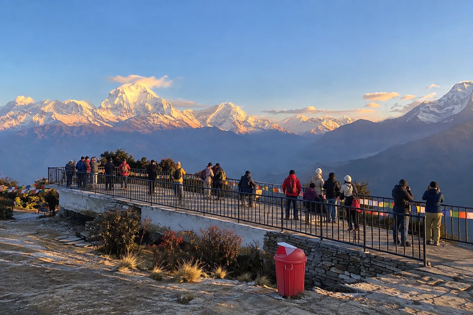 Trekkers watching the sunrise over the Annapurna and Dhaulagiri ranges from Poon Hill in Nepal