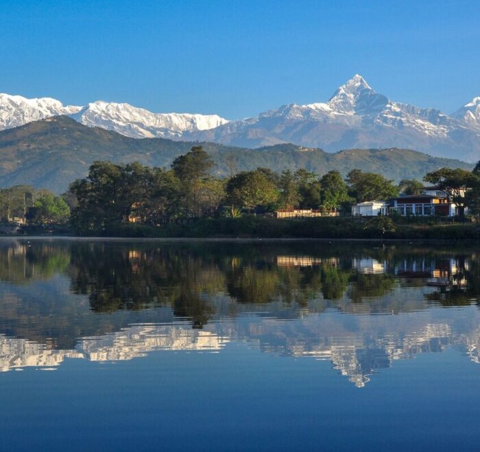 Machhapuchhre and the Annapurna range reflected in Phewa Lake, Pokhara, on a clear morning