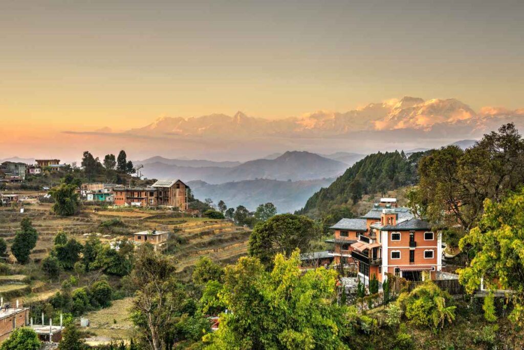 Bandipur village on its ridge at sunrise, with terraced fields below and the Himalaya behind