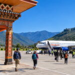 Plane at Paro International Airport with Himalayan hills around the valley