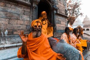 Sadhus at Pashupatinath, Kathmandu Sadhus in orange robes with painted faces sitting at Pashupatinath Temple in Kathmandu